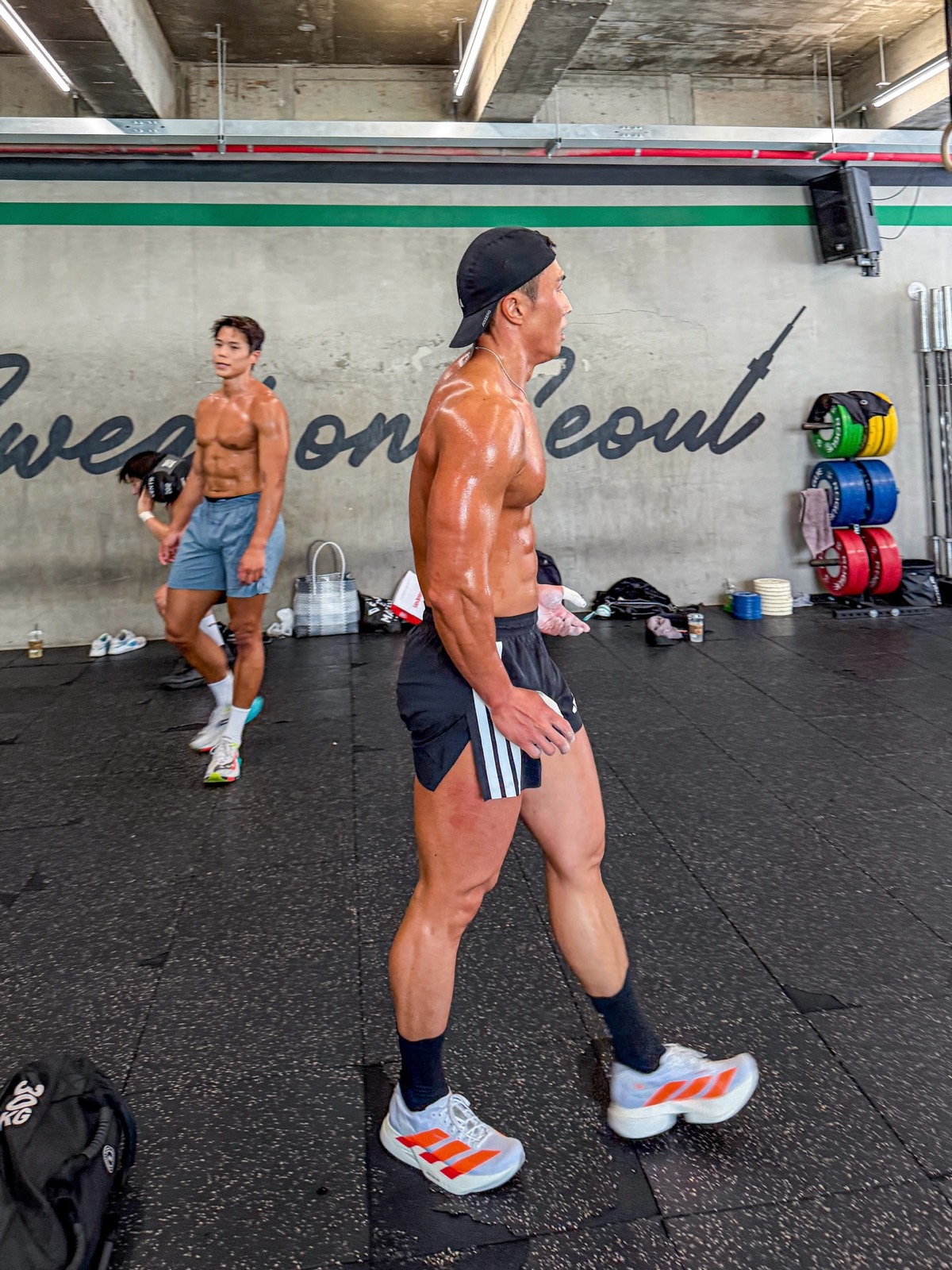 Inside Sweat on Seoul: the training floor in front of the wall lettered “Sweat on Seoul”